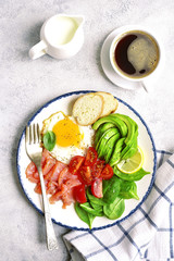 Fried egg,salted salmon,tomato,spinach and avocado - concept of healthy breakfast.Top view.