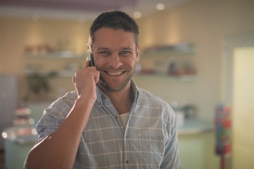 Man talking on mobile phone in restaurant