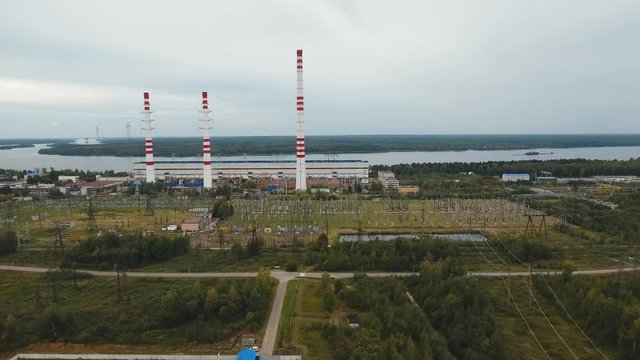 Aerial view Hydroelectric power station, transformation station, cables and wires. High voltage electric power substation. Electrical power transformer in high voltage substation, 4K, aerial footage.
