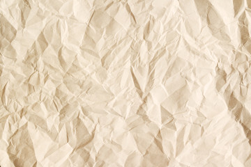 Old crumpled parchment texture. Beige aged paper sheet background.