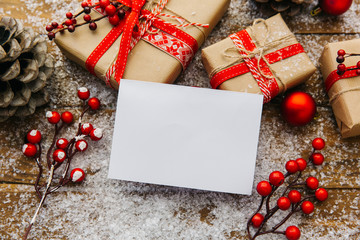 Christmas Decoration with white blank and gift boxes Over Wooden Background