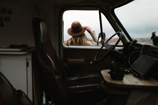 woman standing outside of van window looking out into landscape
