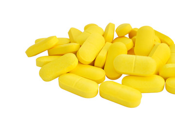  yellow pills and white isolated background
