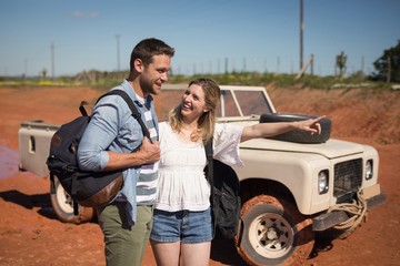 Couple standing together with backpack