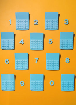 Blue pocket calculators with numbers on orange background.