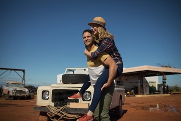 Man giving a piggyback ride to woman