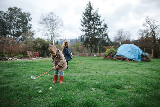 Young kids learning to golf together