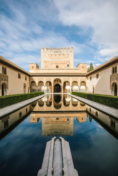 andalusian palace - Comares tower - reflecting in a pond of the Court of the Myrtles, granada, spain
