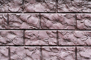 Texture of a brown decorative brick wall. Can be used as a background in interior design.