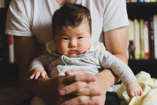 Little baby in dad's lap