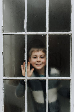 Little Boy Behind Window