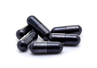 Charcoal capsules isolated on white background