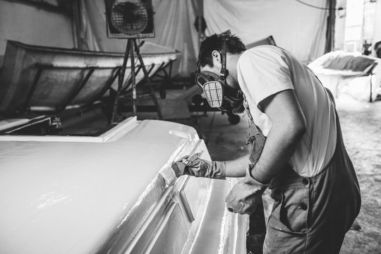 Man in mask brushing construction in white color - black and whi