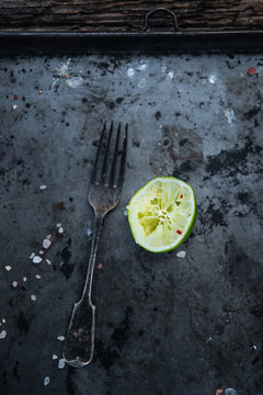 old vintage metal tray with lime and fork