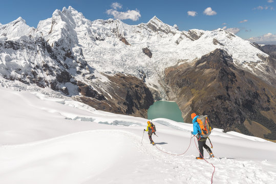 Mountain Climbers walking downhill on glacier