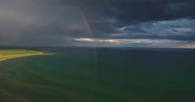 Flying towards a Rainbow Reflecting into a Lake