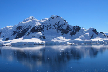 Antarctic mountains and reflections