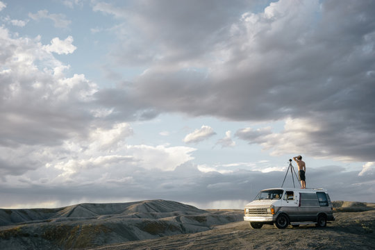 Photographer capturing a timelapse from on top of his van