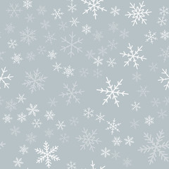 White snowflakes seamless pattern on light grey Christmas background. Chaotic scattered white snowflakes. Bewitching Christmas creative pattern. Vector illustration.