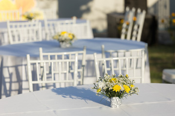 Flowers decoration on white table outdoor in  wedding reception