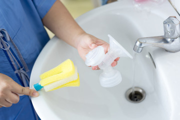 New mother washing the  automatic breast pump.