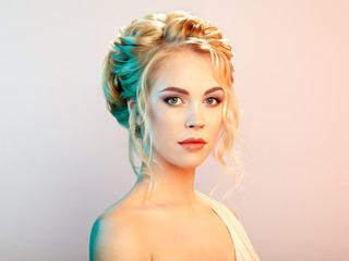 Fototapeta premium Blonde Girl with Long and shiny Curly Hair. Beautiful Model Woman with Curly Hairstyle. Care and Beauty Hair products. Perfect Make-Up