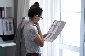 Fashion designer holding a document