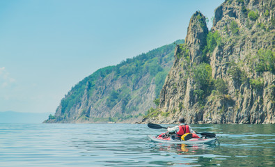 Naklejka na ściany i meble Mеn kayaking on Lake Baikal. Landscape. Siberia.