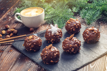 Homemade Christmas or New Year holiday chocolate brownies with nuts on wooden background. Concept of festive desserts