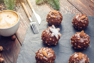 Homemade Christmas or New Year holiday chocolate brownies with nuts on wooden background. Concept of festive desserts