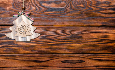 Fototapeta premium Christmas toy lies on a brown wooden background 
