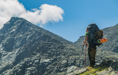 Men hiking in mountains. Siberia.