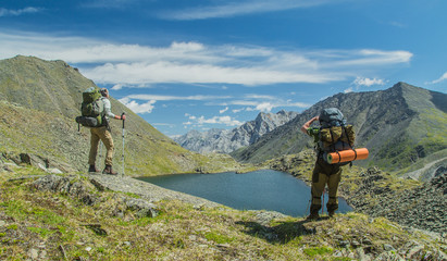 Men hiking in mountains. Siberia.