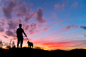 Silhouette man with dog and sunset