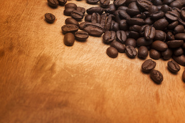 Coffee beans on the wooden board.Close up shot with selective focus.
