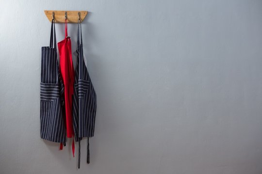 Various aprons hanging on hook