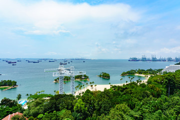 Fototapeta na wymiar panorama landscape view of singapore sea and siloso beach with blue sky and cloud, POV from cable car.