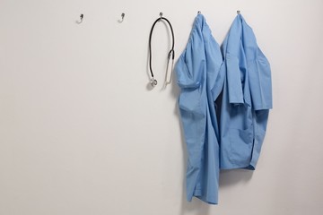 Scrubs and stethoscope hanging on hook