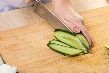 chef cuts cucumber