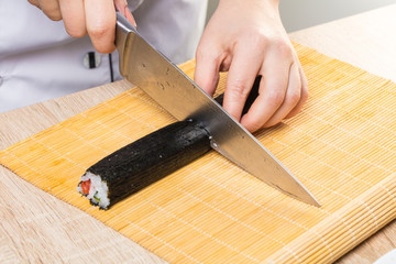 Chef cuts rolls, hands close-up