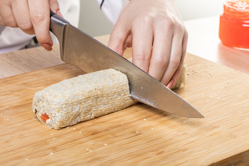 Chef cuts rolls, hands close-up