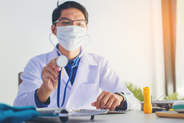 Smart doctor with stethoscope ready for diagnose at clinic