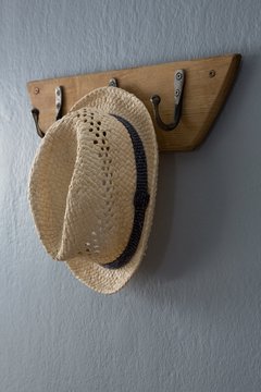 Straw hat hanging on hook