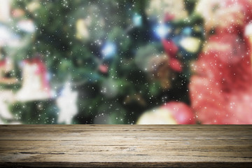 Wood table top on bokeh Christmas background.