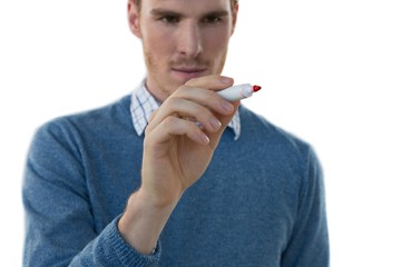 Male executive writing on invisible screen