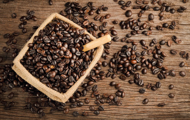 Coffee Bean inside Sack and wood spoon on wood block still life lighting style