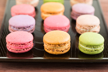 Fototapeta na wymiar Macarons on a lacquer tray close up