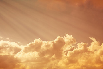 Dramatic view of a orange sunset clouds illuminated by sun rays (background, toned, copy space)