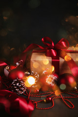 Composition with Christmas decorations  and gift on black background toned bokeh