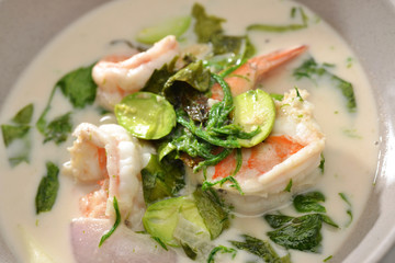 Thai food spicy shrimp and vegetable Parkia speciosa curry in coconut milk close up